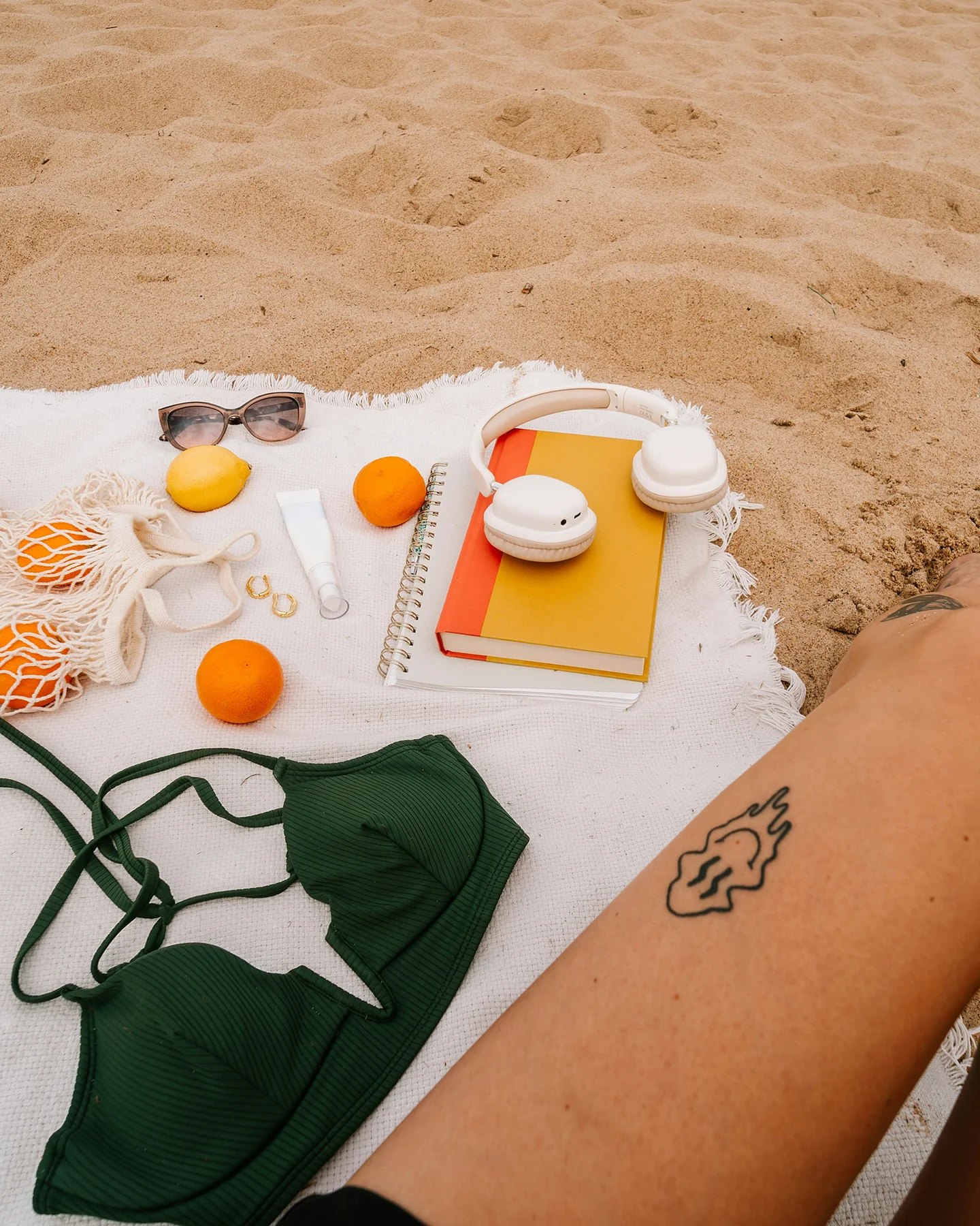 Beach picnic with oranges and sunglasses