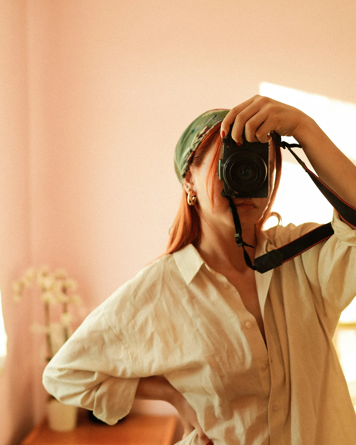 Woman taking a photo with a film camera