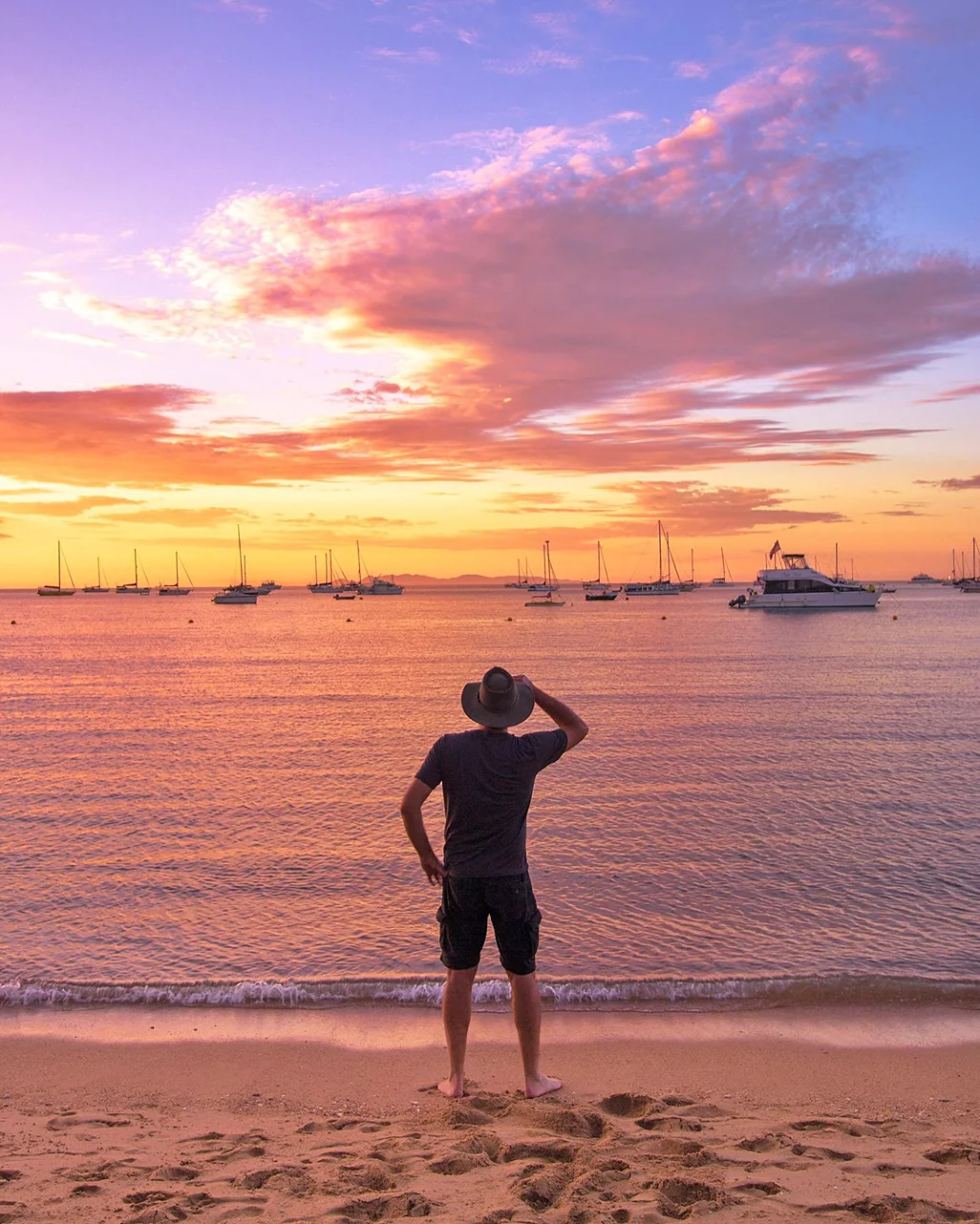 Person on a beach at a pink sunset