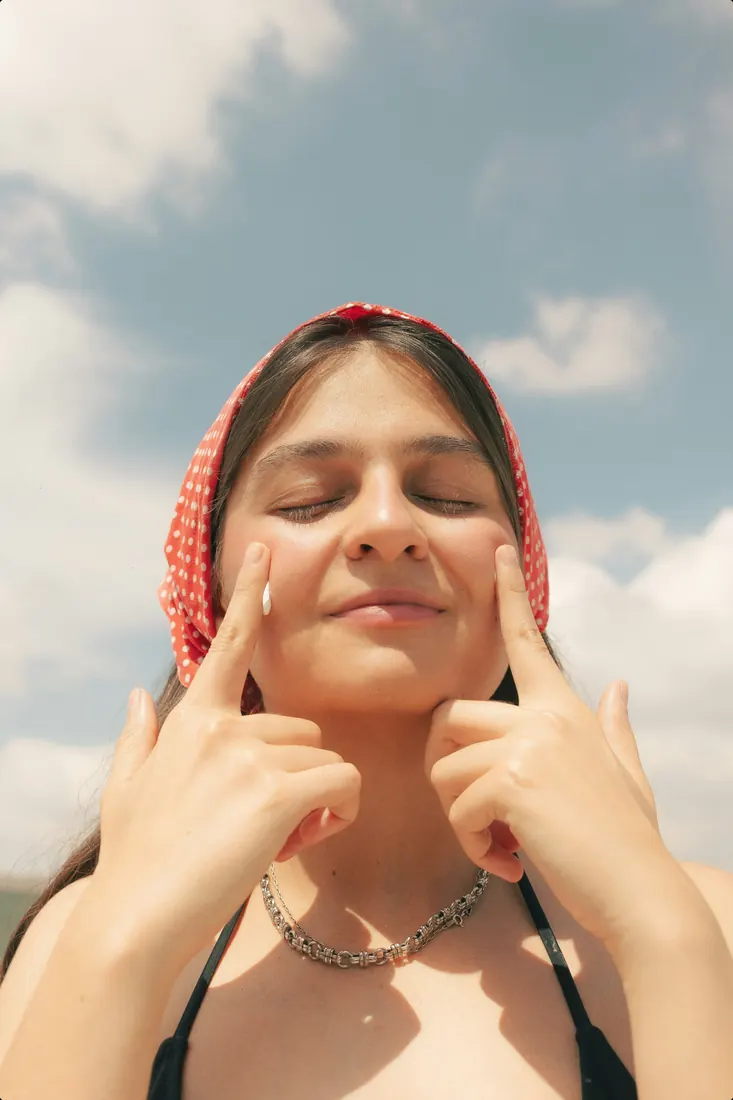 Woman in a red bandana smiling in the sun