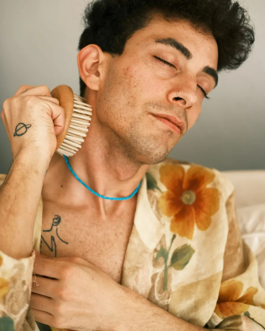 Man in a floral shirt with eyes closed