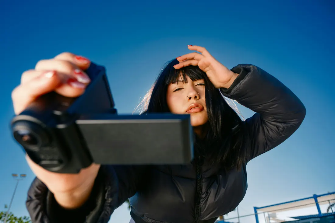 Creator filming a vlog on her phone